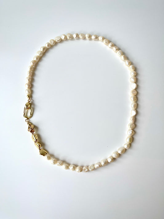 White freshwater baroque pearl necklace on a white background