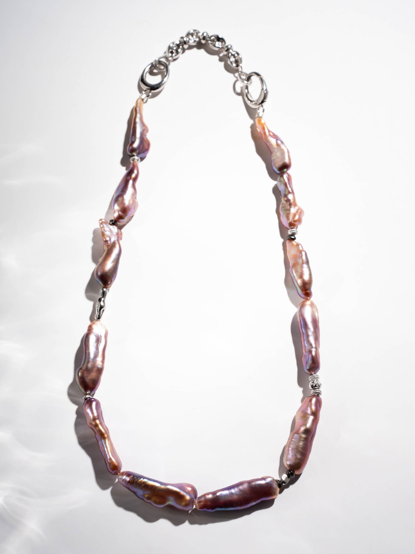 Pearl Necklace with pink and purple beads on a white background