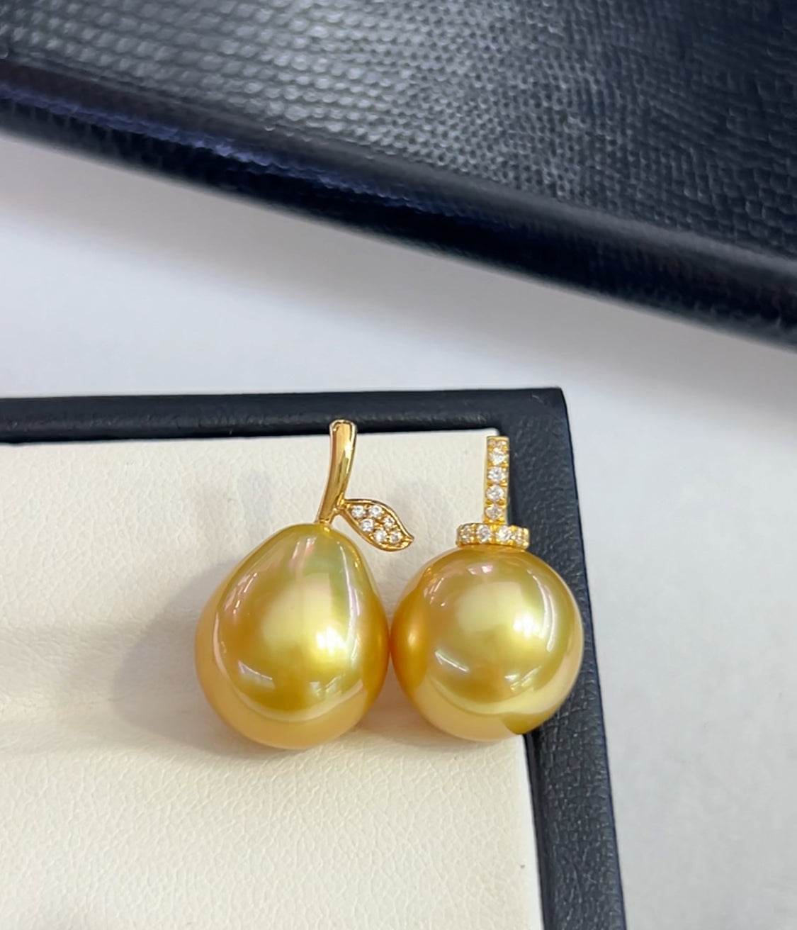 South Sea golden pearl pendant with accents in 18k gold on a white and blue background