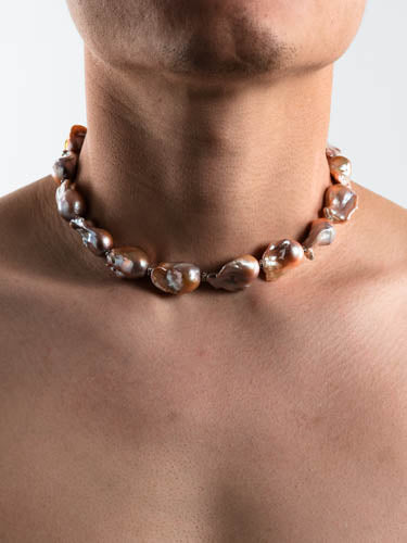Male model wearing a chunky baroque pearl necklace