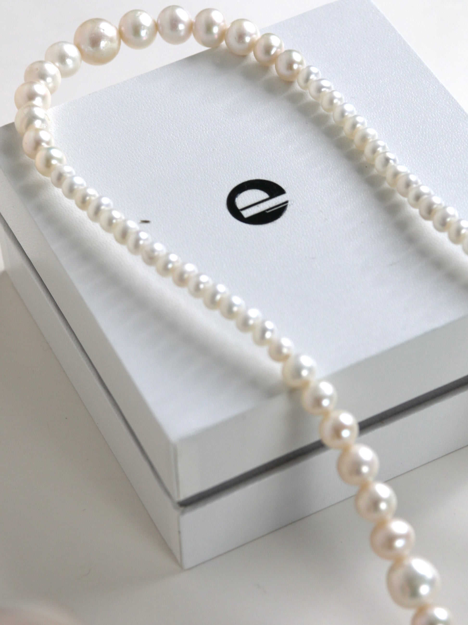 Pearl necklace for men on a branded jewelry box