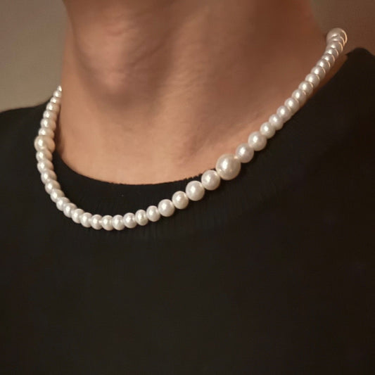 Audrey Hepburn style white freshwater pearl necklace worn by a person
