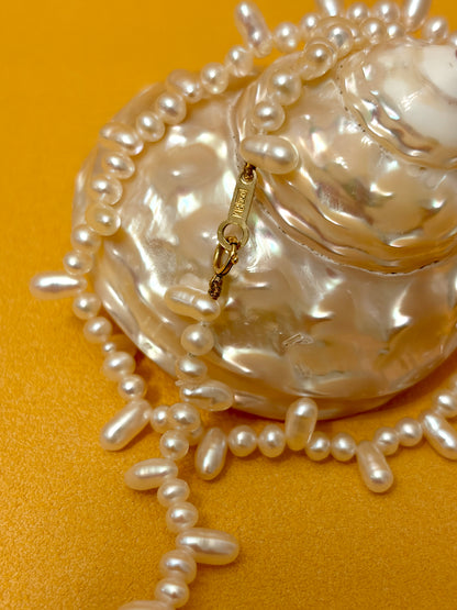 Aurora Luster Wild Keshi Pearl Choker Necklace features natural pearls and an 18K solid gold clasp on a beautiful shell.