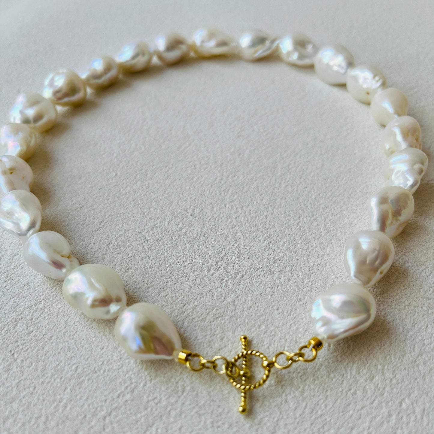 Baroque pearl necklace featuring distinctive stone-shaped pearls and 24K gold vermeil clasp.