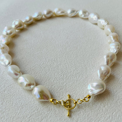 Baroque pearl necklace featuring distinctive stone-shaped pearls and 24K gold vermeil clasp.