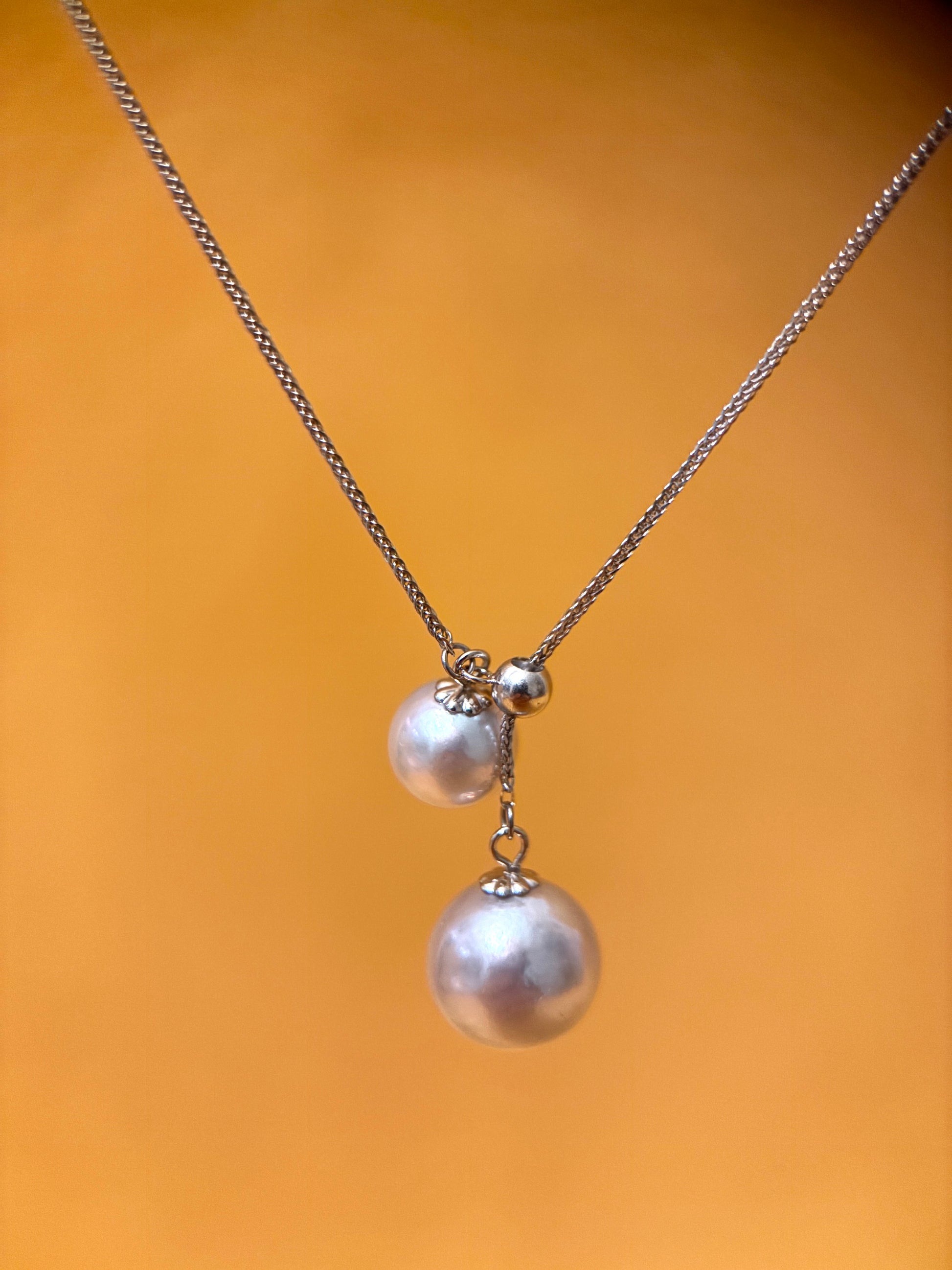 Akoya pearl pendant necklace featuring two elegantly displayed pearls on a delicate chain.