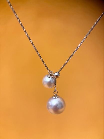 Akoya pearl pendant necklace featuring two elegantly displayed pearls on a delicate chain.