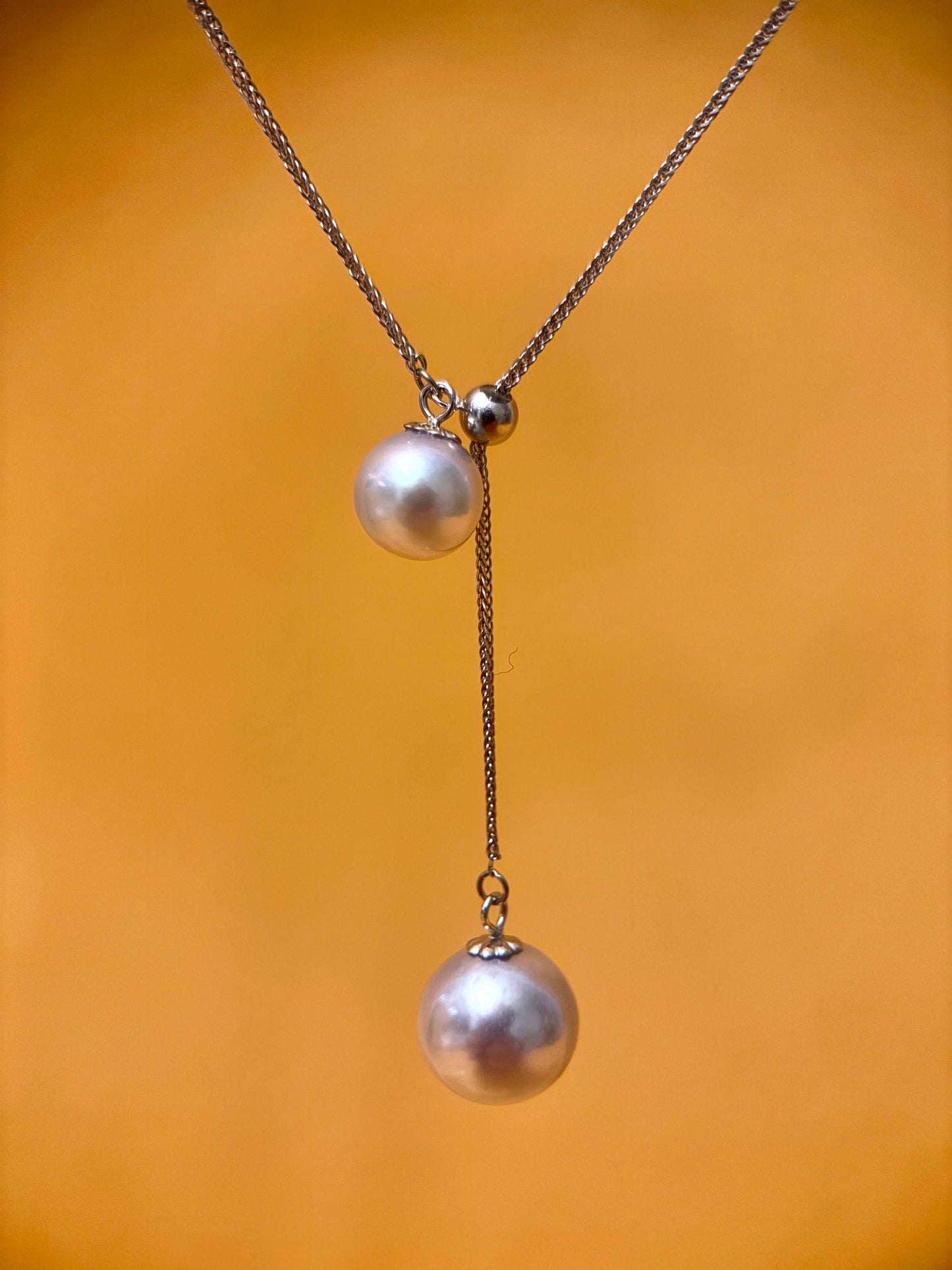 Blue Silver-Gray Akoya pearl pendant necklace on a delicate chain, symbolizing elegance and good fortune.