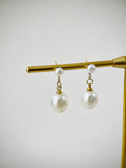 Pearl earrings with gold hooks on a white background