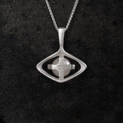 Silver pearl pendant necklace on a dark textured background