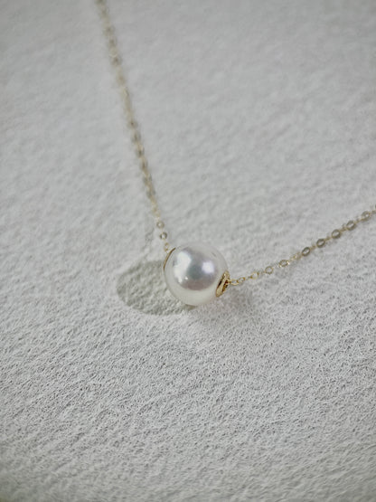 Pearl necklace on a textured gray surface