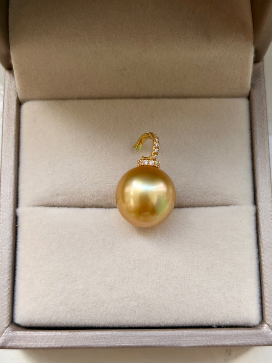 golden South Sea pearl pendant with accents in 18k gold in a jewelry box