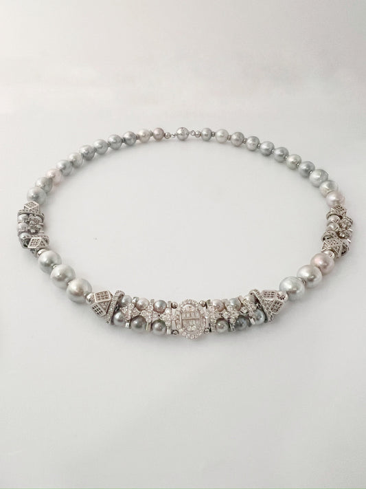 Pearl and silver beaded necklace on a white background