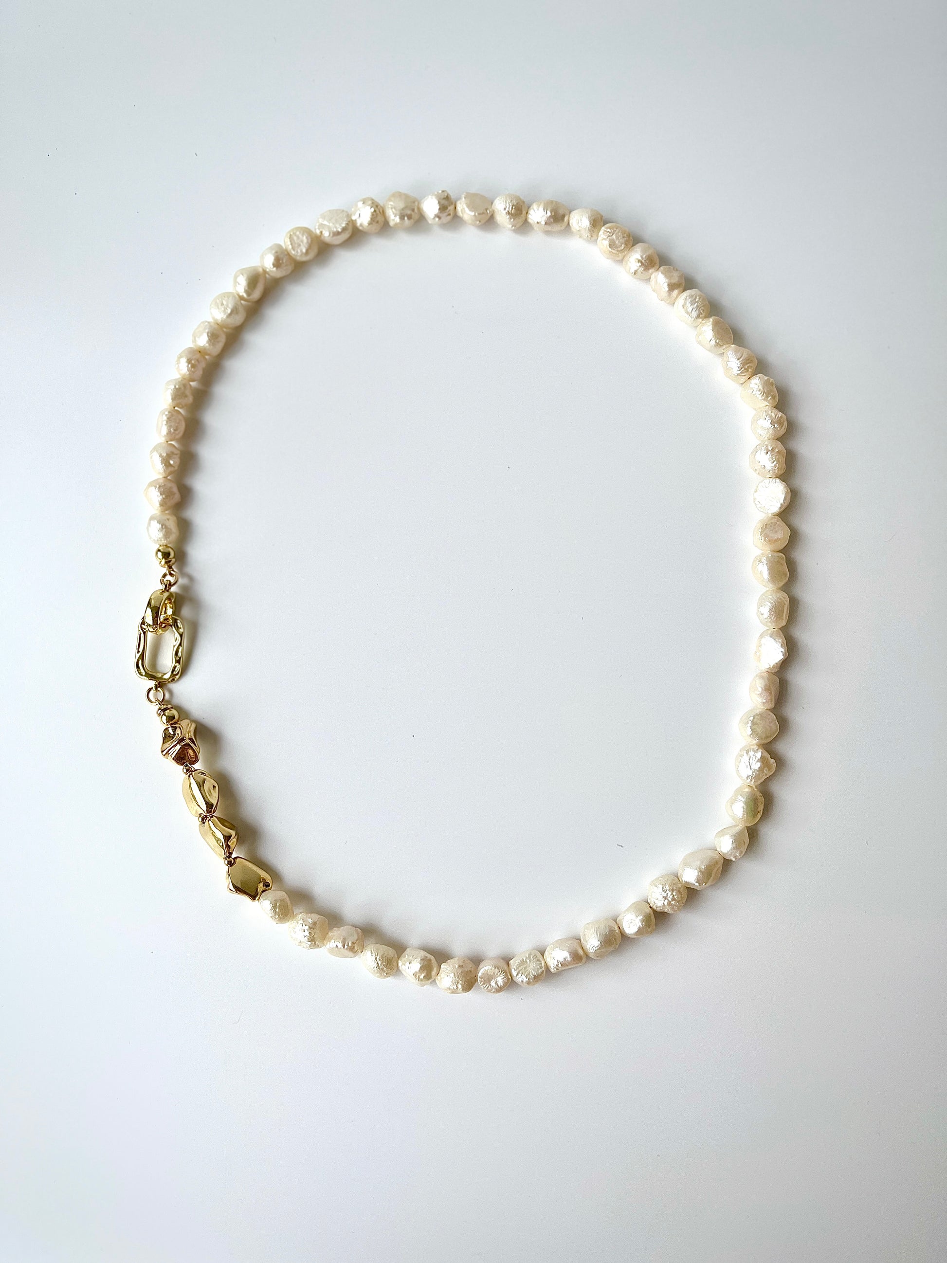 White freshwater baroque pearl necklace on a white background
