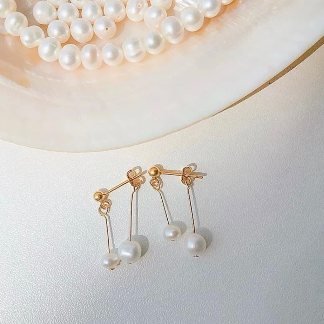 Pearl earrings on a light background