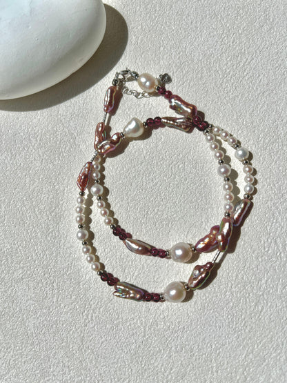 Multistrand pearl and beaded necklace on a light surface