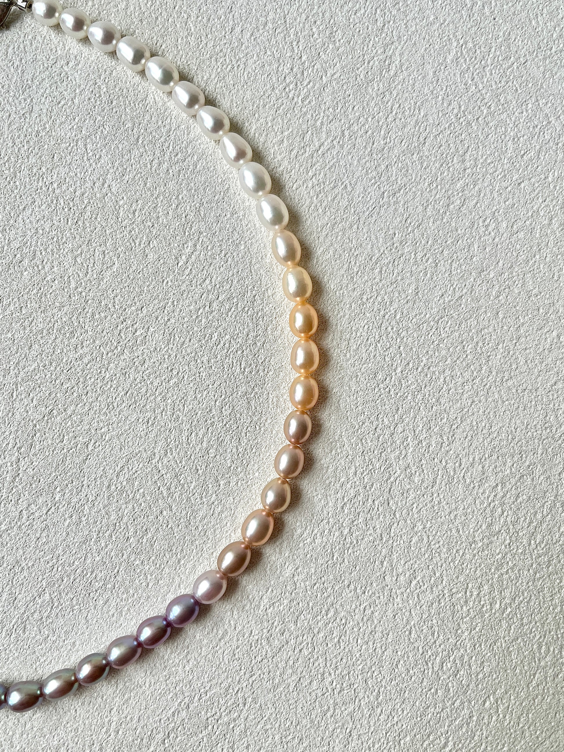 Pearl necklace on a light gray background