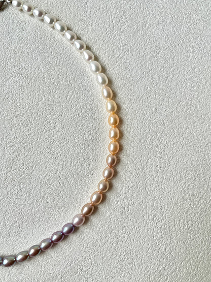 Pearl necklace on a light gray background