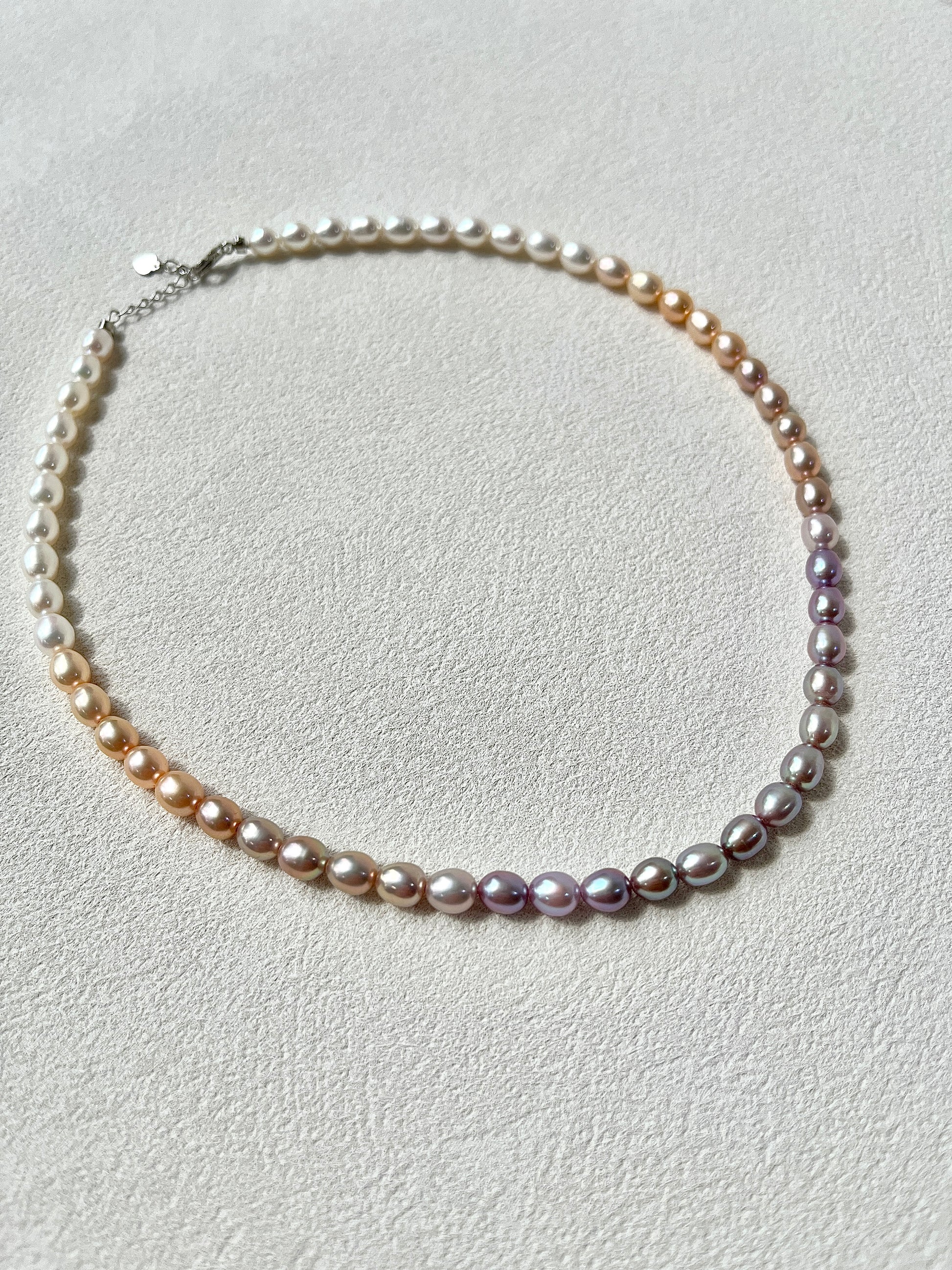 Pearl necklace on a light gray background