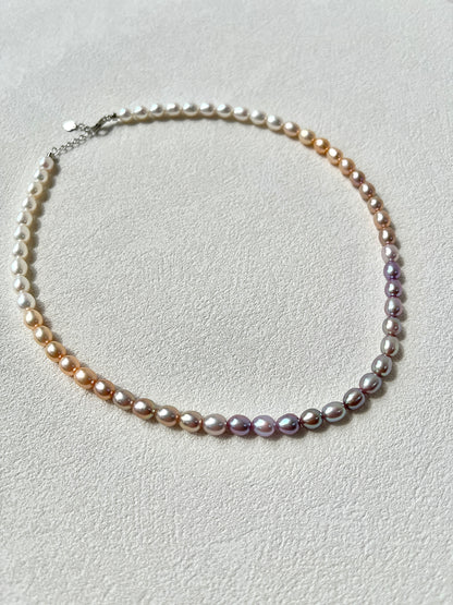 Pearl necklace on a light gray background