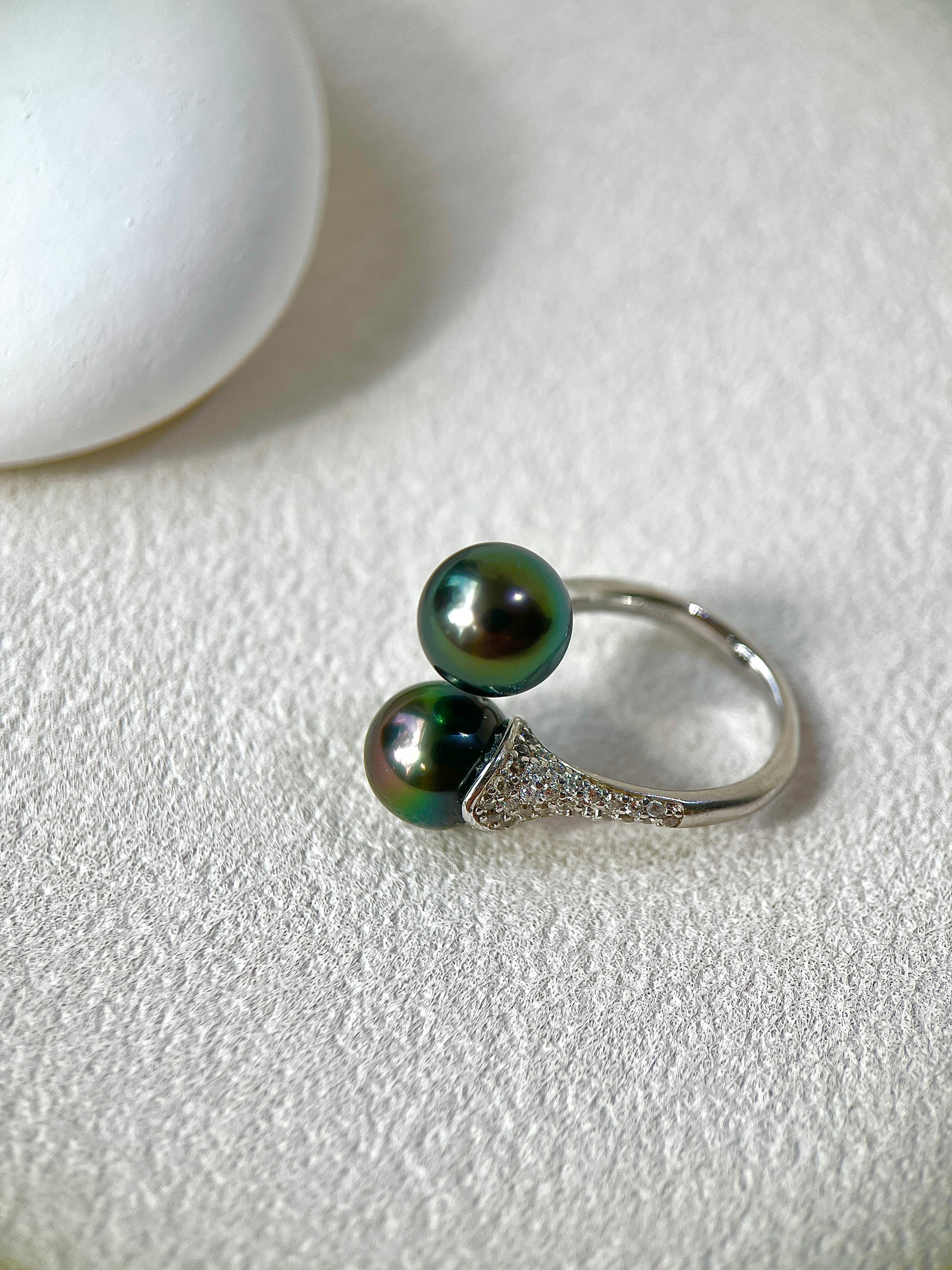 Tahitian Black Pearl ring with silver setting on a white surface