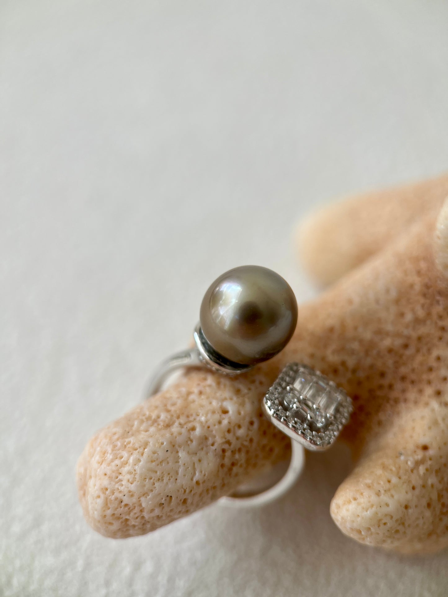 tahitian black Pearl ring on a hand with a neutral background