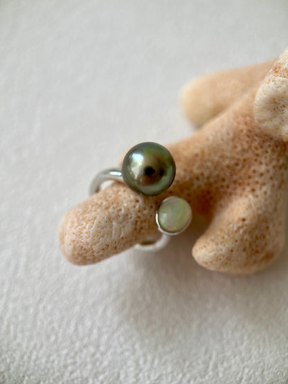 Tahitian Black pearl ring with Opal on a hand with a neutral background