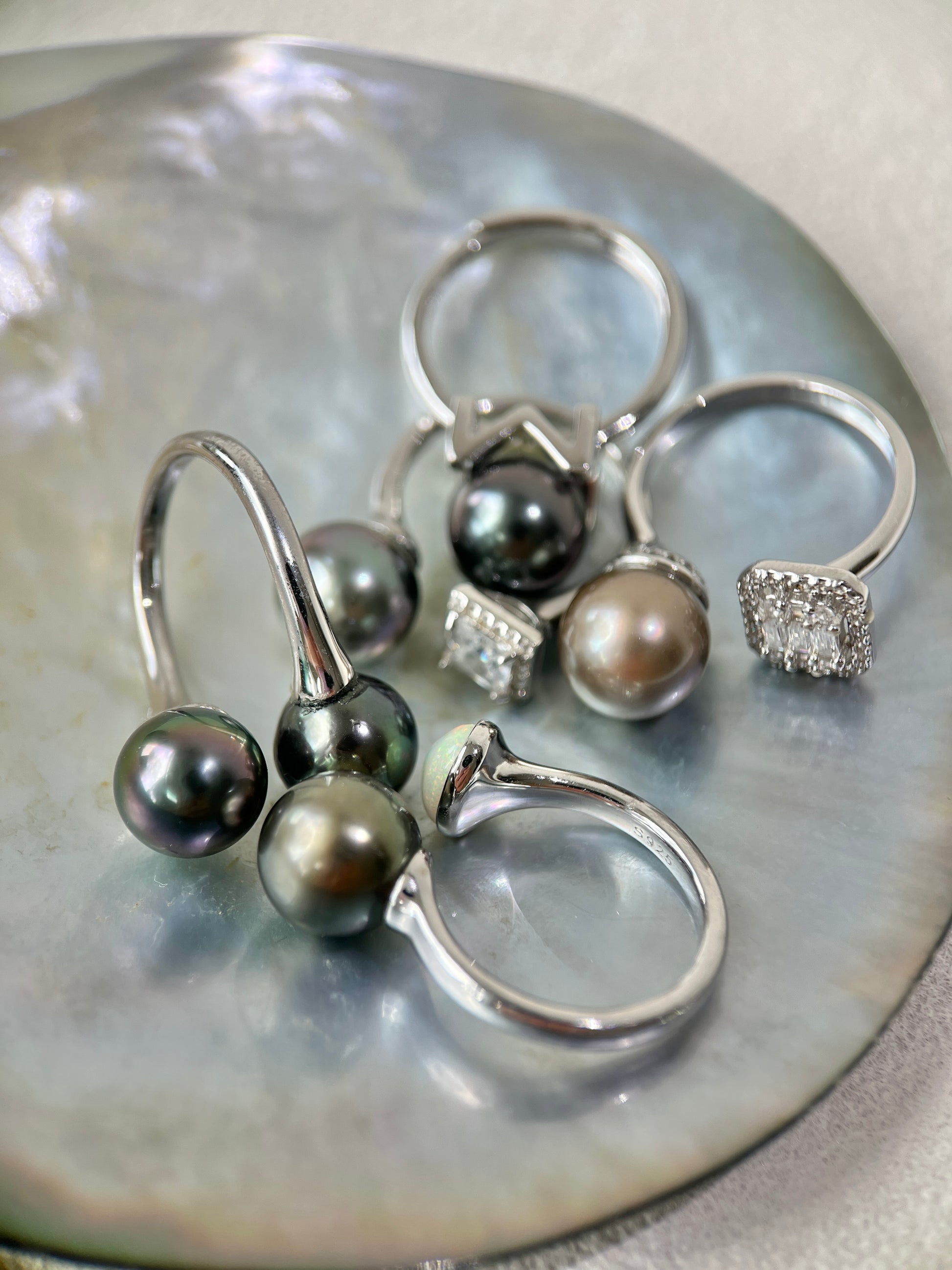 Silver ring set with Tahitian pearls on a shell