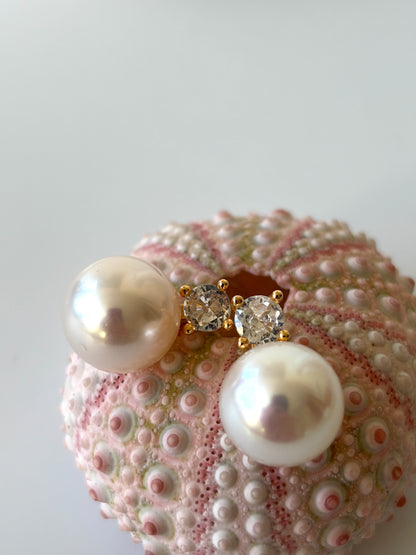 Pearl and crystal earrings on a pink sea urchin