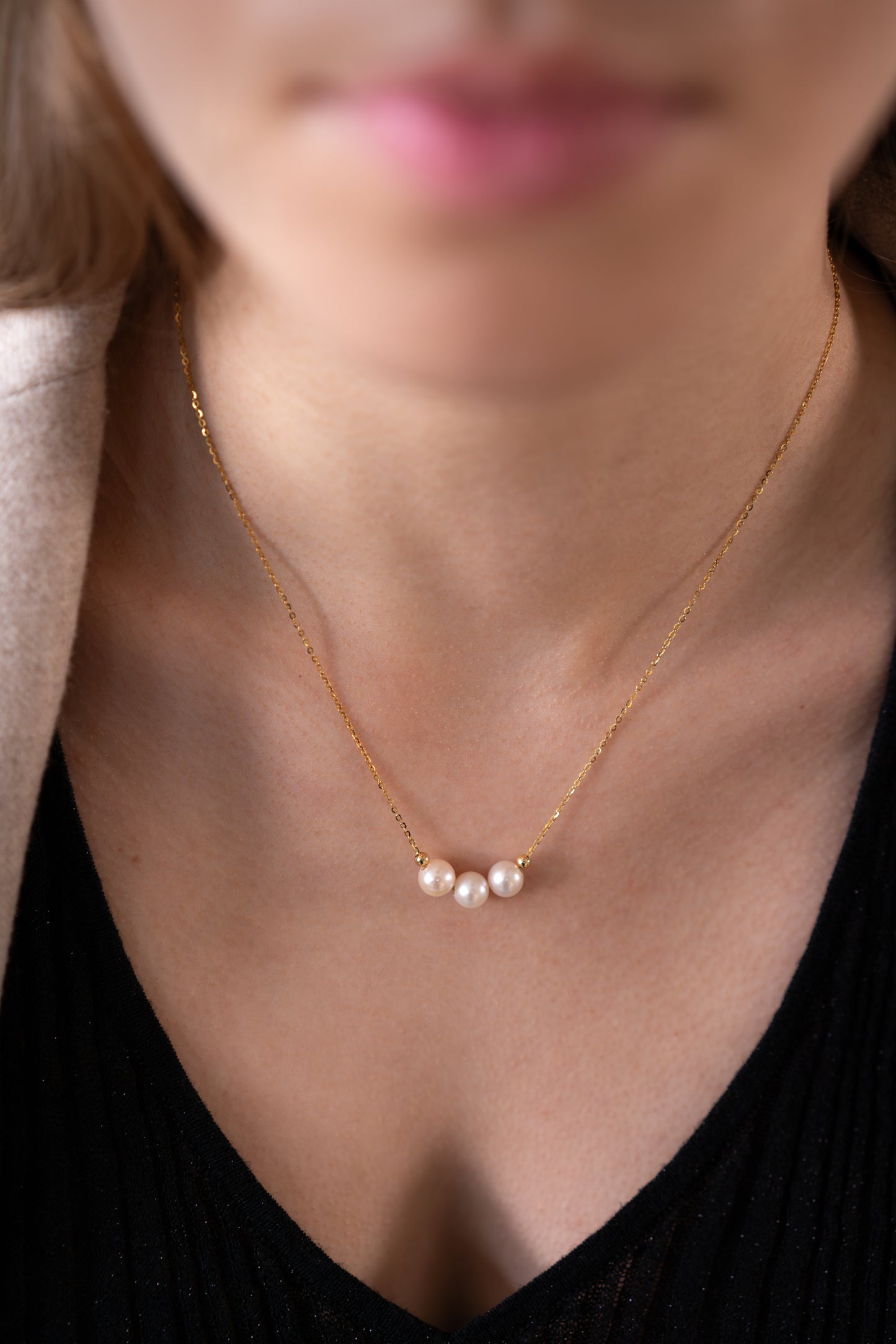 three White Freshwater Pearl Necklace is worn by a model