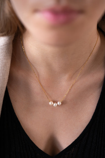 three White Freshwater Pearl Necklace is worn by a model