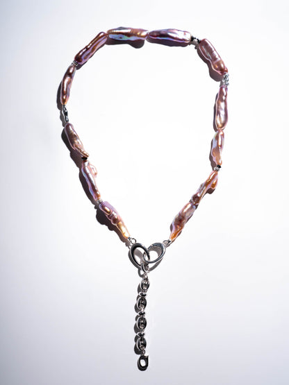 Pearl Necklace with pink and brown beads and a silver clasp on a light gray background