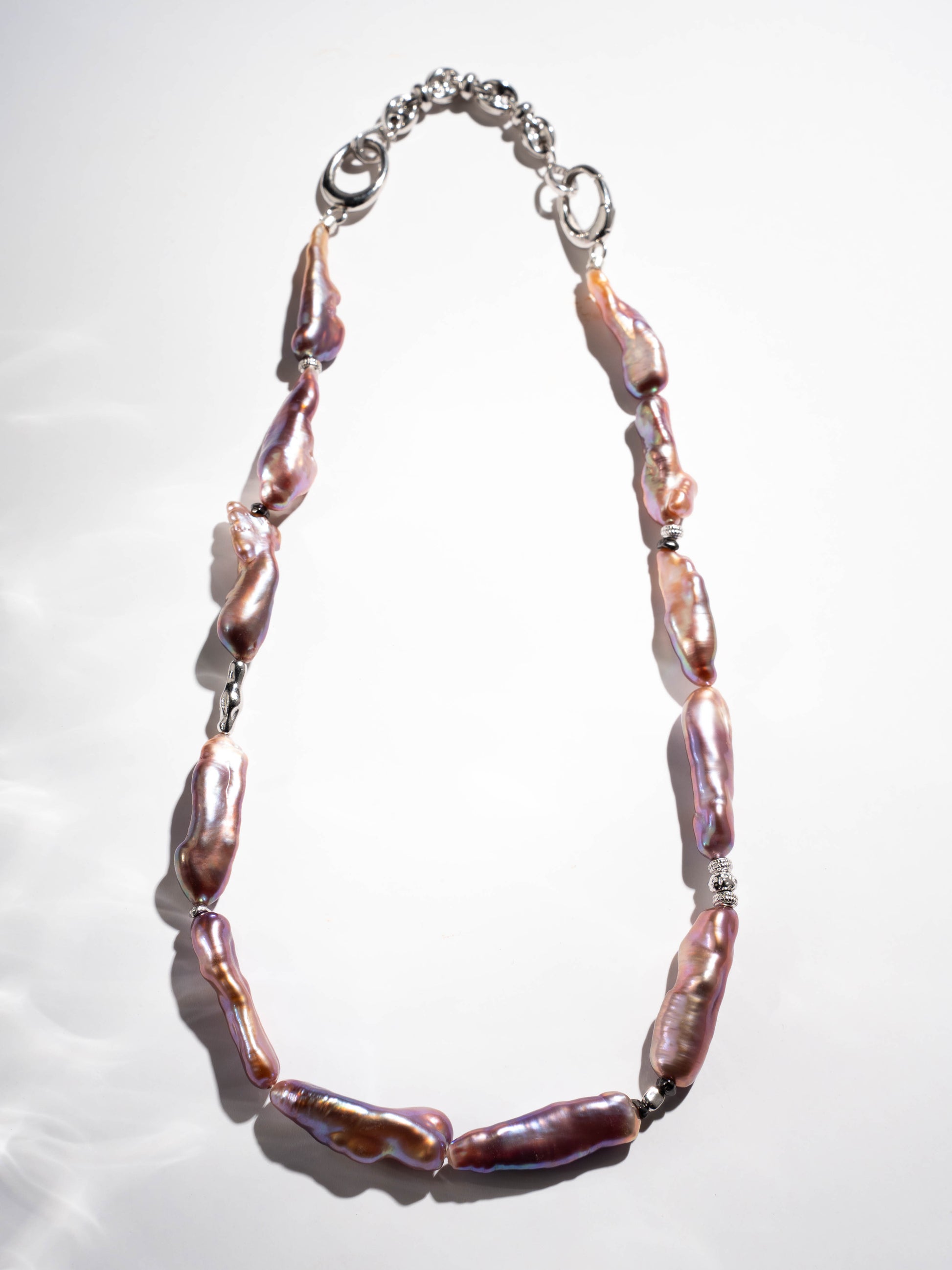 Pearl Necklace with pink and purple beads on a white background