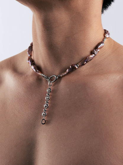Pearl Necklace with a heart-shaped clasp on a person's neck against a neutral background