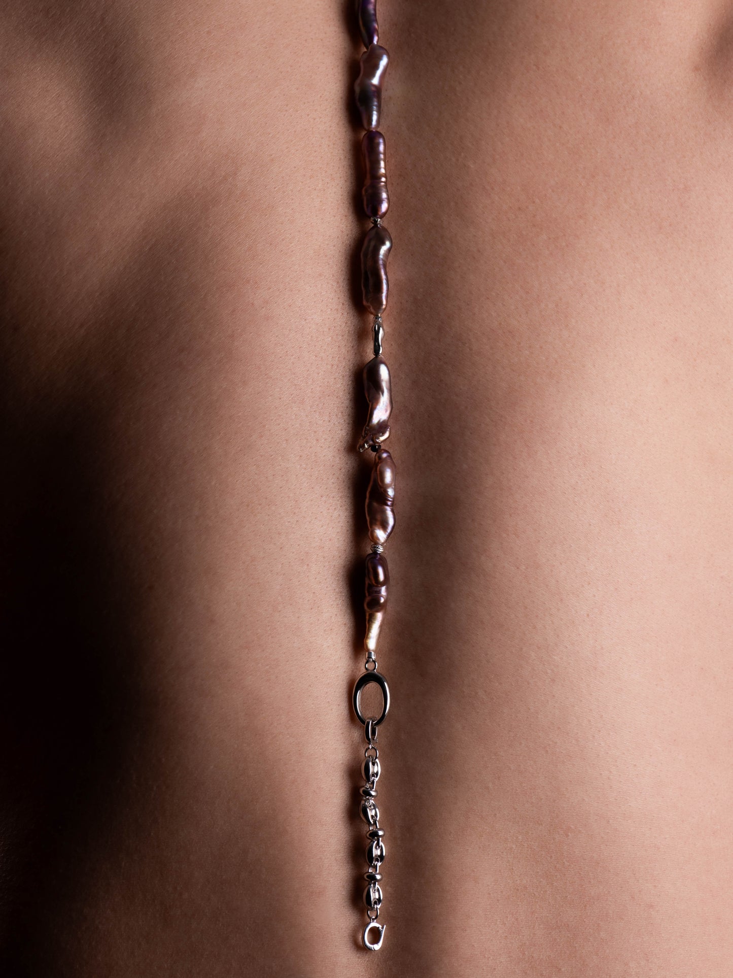 Close-up of a Pearl necklace with beads on a person's neck