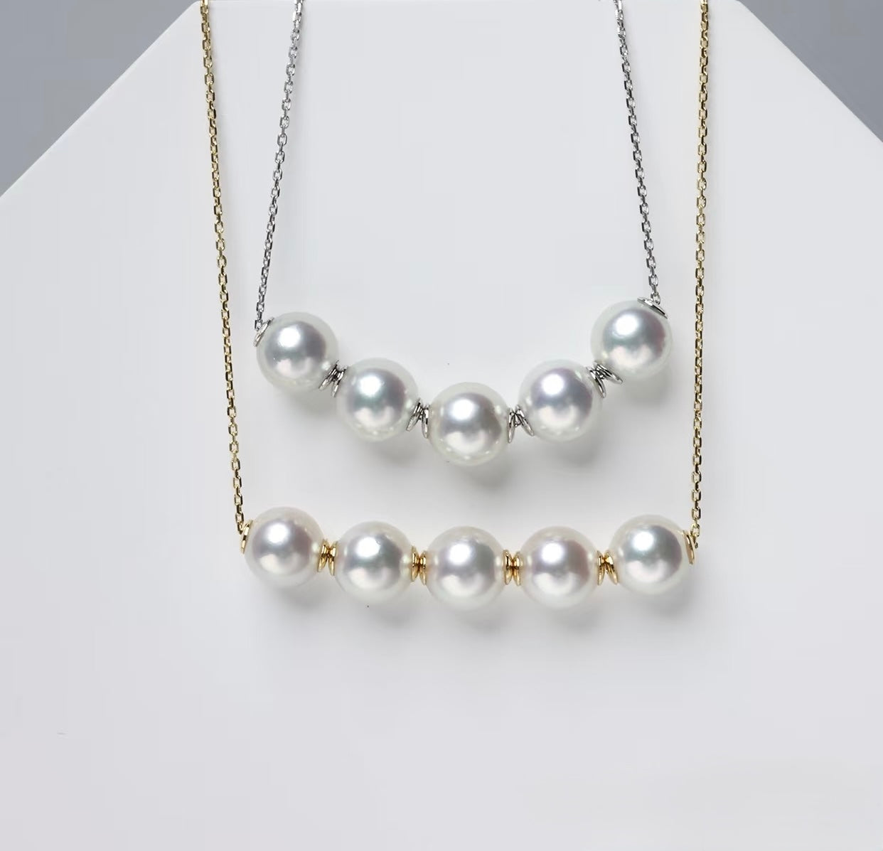 Adjustable freshwater pearl necklace featuring round pearls on 18K solid gold and silver chain.