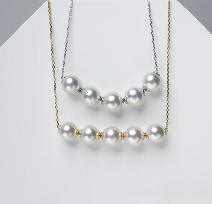 Adjustable freshwater pearl necklace featuring round pearls on 18K solid gold and silver chain.