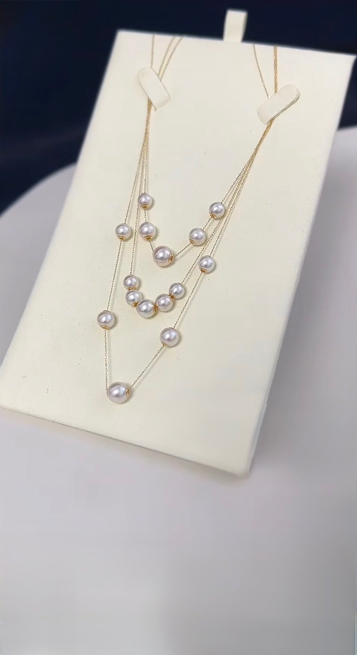 Adjustable freshwater pearl necklace featuring multiple round pearls on an 18K solid gold chain.