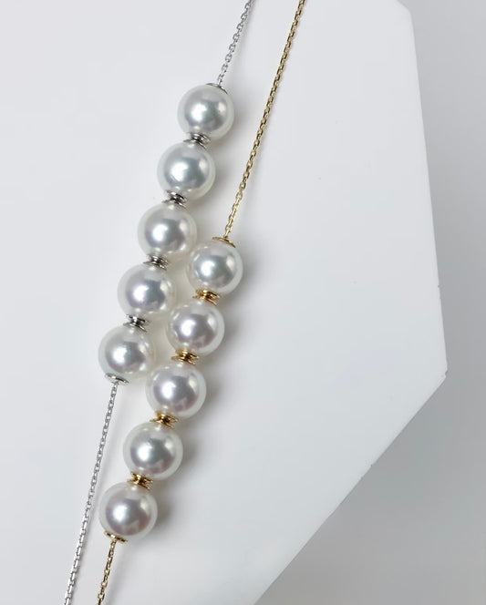 Adjustable freshwater pearl necklace featuring round pearls and 18K solid gold chain for versatile styling.