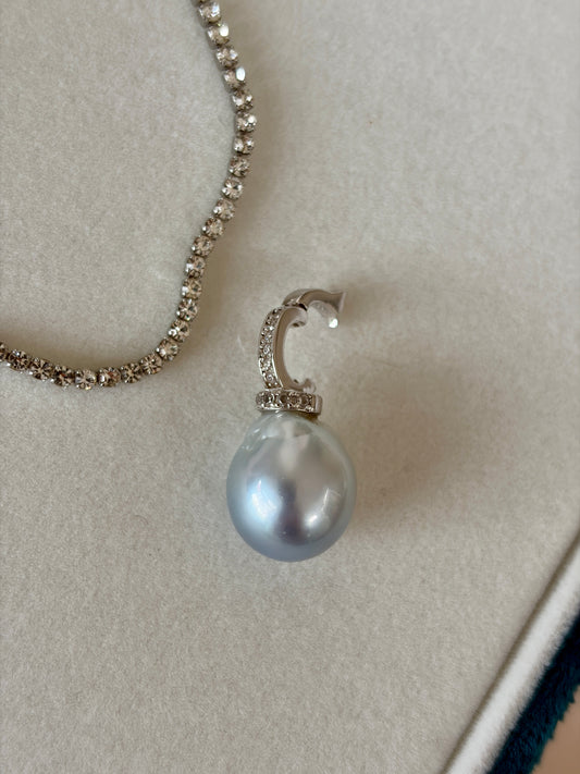 South Sea baroque pearl pendant on a chain against a neutral background