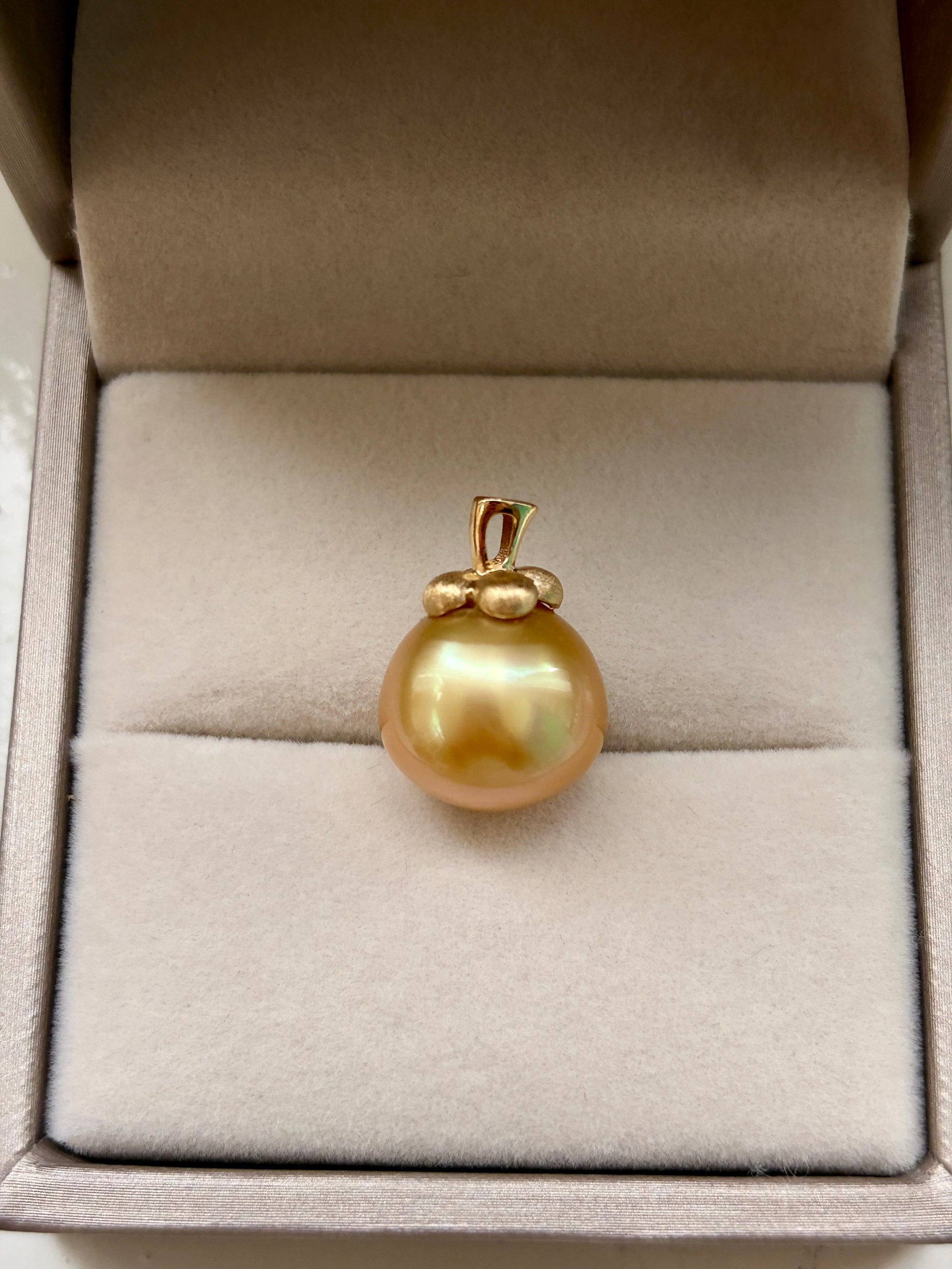 South Sea golden pearl pendant in an open jewelry box.