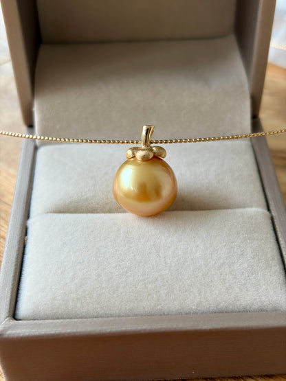South Sea golden pearl pendant in an open jewelry box.