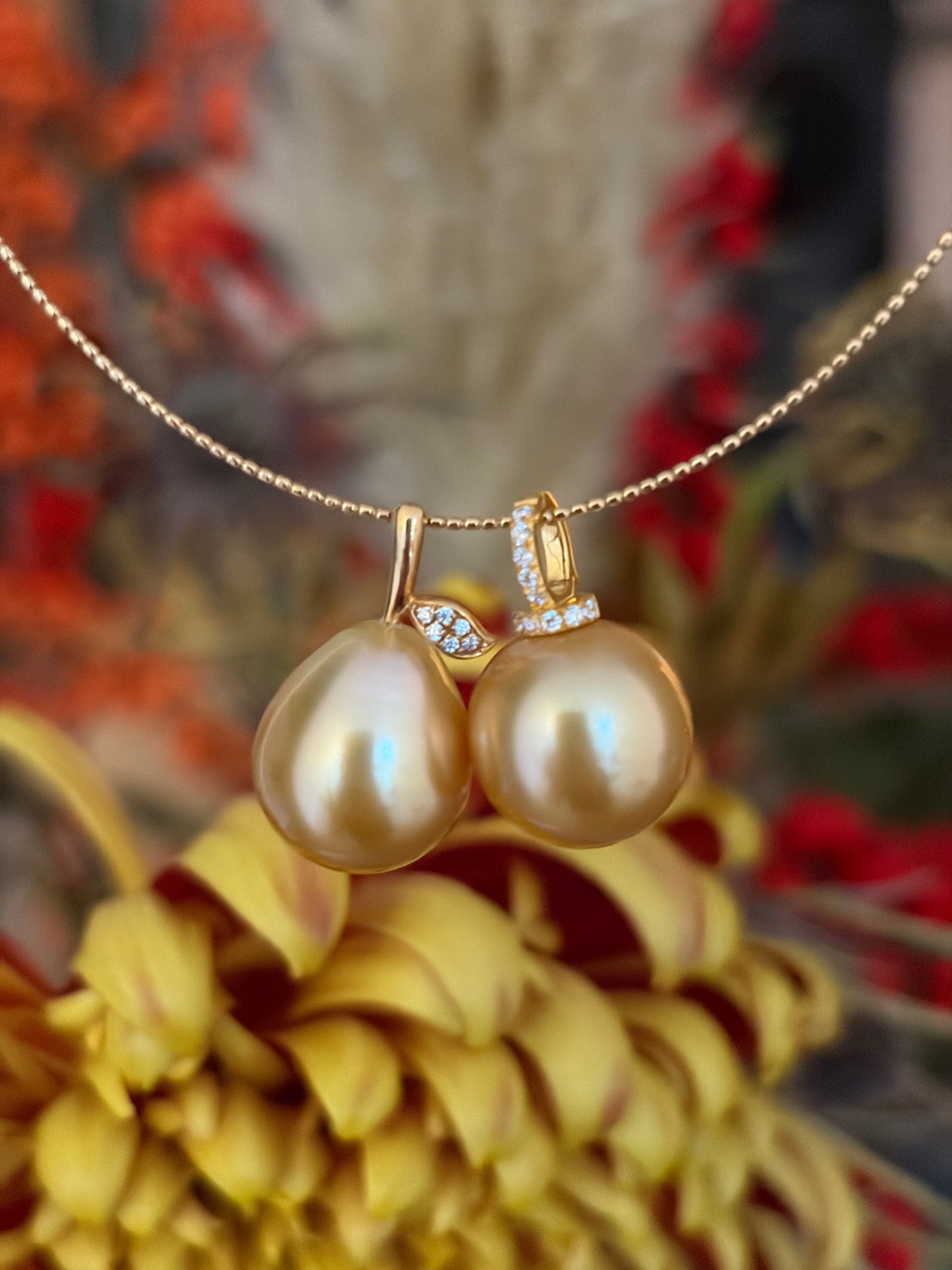 South Sea golden pearl pendant on a gold chain necklace on a decorative background