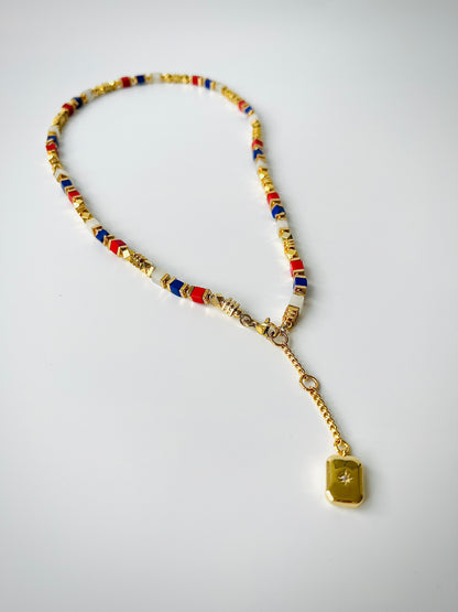 Necklace with colorful beads and a gold pendant on a white background