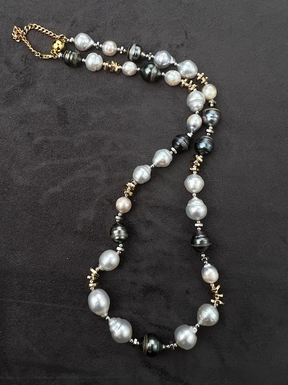 Necklace with Tahitian and South Sear pearls and gold accents on a dark background