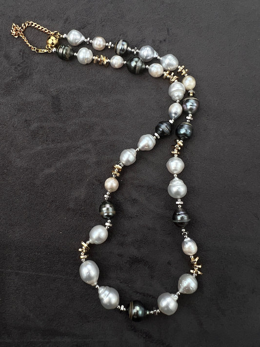 Necklace with Tahitian and South Sear pearls and gold accents on a dark background