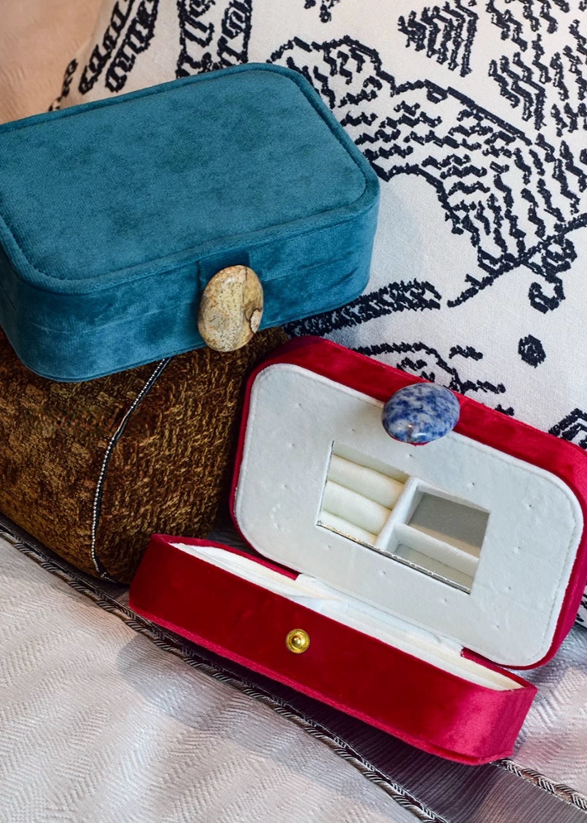 Jewelry box in blue and red base on a patterned surface
