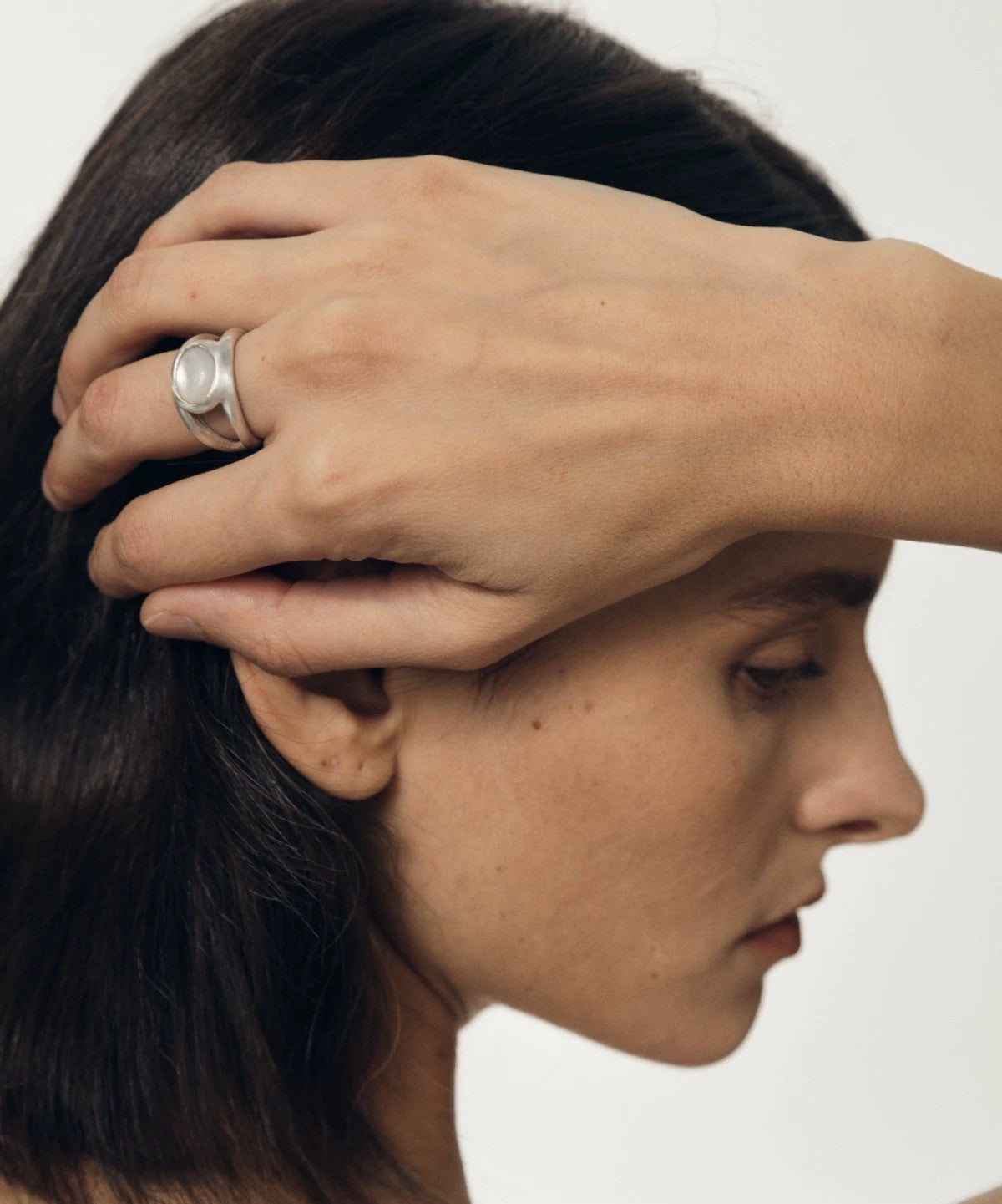 Close-up of a model wearing a vintage double layer silver ring with nacre gemstone, showcasing timeless elegance.