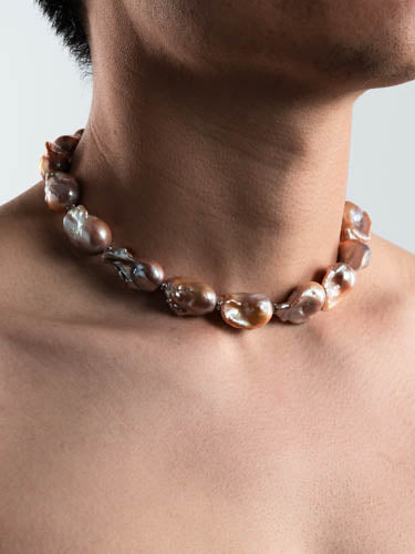 Male model wearing baroque pearl necklace with high luster