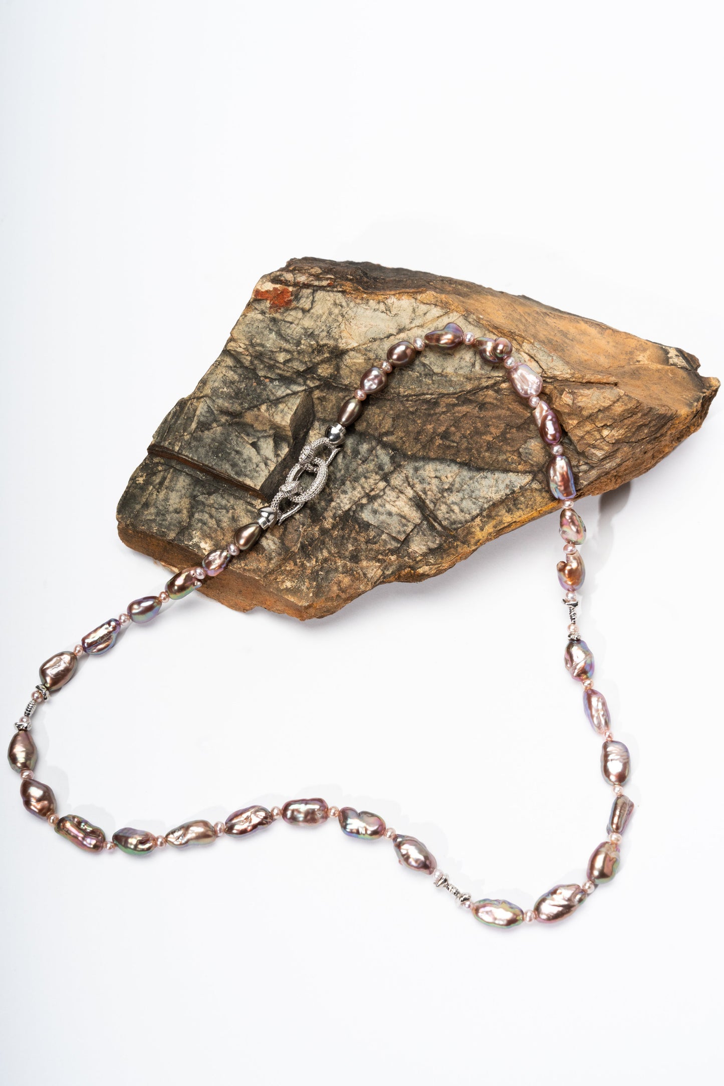 Necklace with pink Keshi pearls on a rock